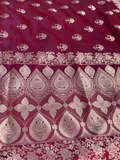 Red fabric with white intricate patterns on a white background